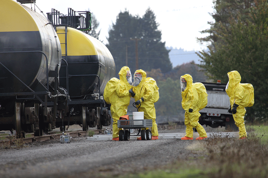 HAZMAT team working in front of train cars